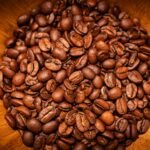 a wooden bowl filled with lots of coffee beans